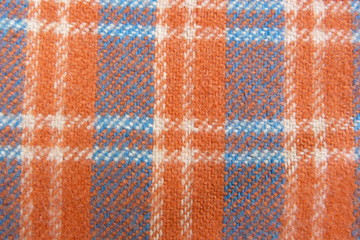 Fototapeta na wymiar checkered fabric close-up macro background decor orange white blue cells stripes geometric pattern