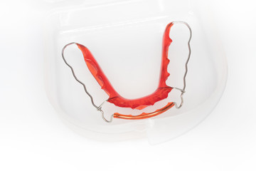 red orthodontic retainer in white box