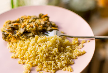 Stewed chicken hearts and porridge - bulgur.