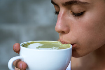 matcha latte tea ceremony of girl. Getting warm with hot tea. perfect morning with green coffee....