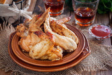 Baked chicken wings on a wooden table, horizontal
