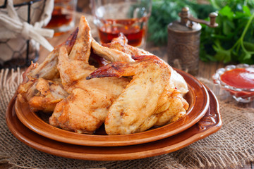 Baked chicken wings on a wooden table, horizontal