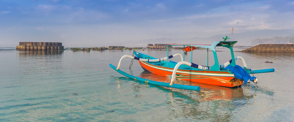 Fototapeta na wymiar Panorama of a traditional indonesian fishing boat at the Candidasa coast of Bali, Indonesia