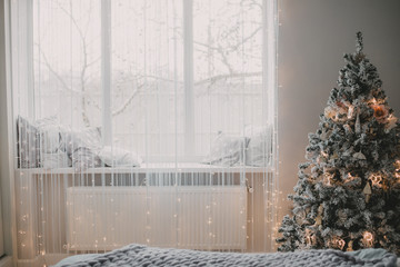 Interior of a bedroom on a Christmas morning. New Year's morning. Elements of the decor of the christmas decoration of the bedroom