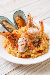 risotto with seafoods (shrimps, mussels, octopus, clams) and tomatoes