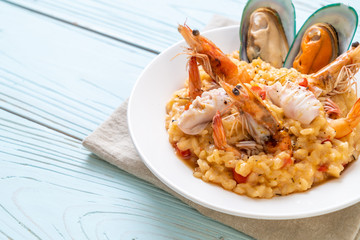 risotto with seafoods (shrimps, mussels, octopus, clams) and tomatoes