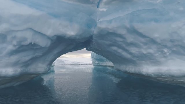 Arch Between Icebergs. Antarctica Winter Landscape. Ice Mountains Connection Among Crystal Clear Ocean Water. Amazing Natural Phenomenon. Wilderness. Beauty Of Virgin Nature. 4k Footage.