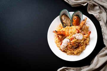 risotto with seafoods (shrimps, mussels, octopus, clams) and tomatoes