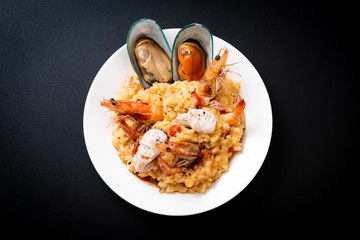 risotto with seafoods (shrimps, mussels, octopus, clams) and tomatoes
