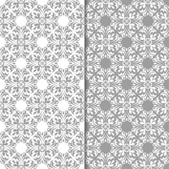 White and gray floral ornamental designs. Set of seamless patterns