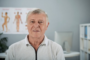 Portrait of elderly man in office of doctor