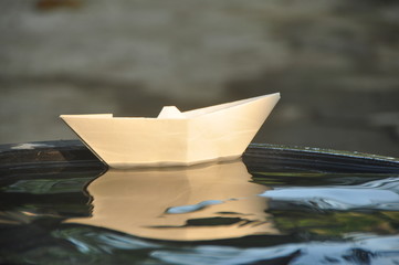 Paper boat in water