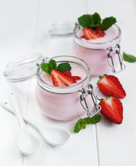 Jars with strawberry yogurt