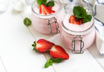 Jars with strawberry yogurt