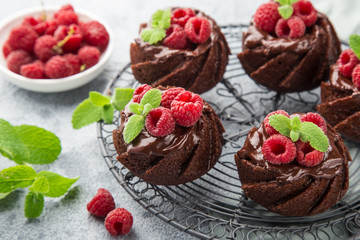 delicious chocolate muffins with chocolate topping and fresh raspberry