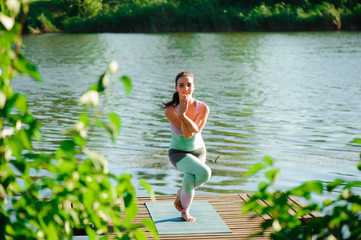 Woman do yoga outdoor. Woman exercising vital and meditation for fitness lifestyle club at the nature background. Concept Yoga