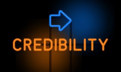 Credibility - orange glowing text with an arrow on dark background