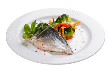 Fillet of dorado with steamed vegetables. On a white plate