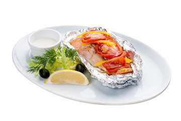 Salmon baked in foil with lemon on a white plate