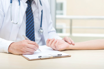 Healthcare concept. Doctor checking heart pulse for patient.