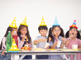group of kids celebrate party and enjoy christmas fun together,Children are exchanging gifts.