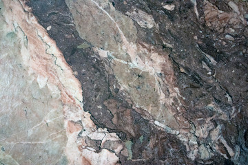 Multicolored layered marble texture with different veins and scratches, may be used as background