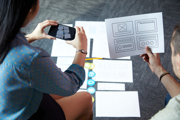 UX and UI designers taking photos of ideas for new website or mobile application