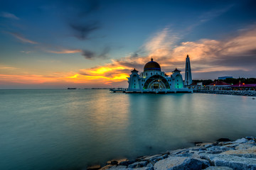 Beautiful sunset over the majestic mosque, Malacca Straits Mosque (Masjid Selat). Soft focus due to slow shutter shot.