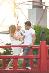 Obraz premium Young family with little kid spending time in amusement park