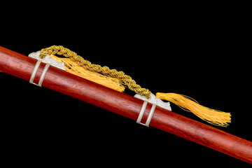 Wooden  scabbard of Chinese sword  isolated in black background.