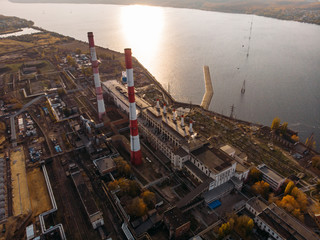 Aerial view of Voronezh Power Plant or station with high chimneys near water reservoir at sunset, drone photo