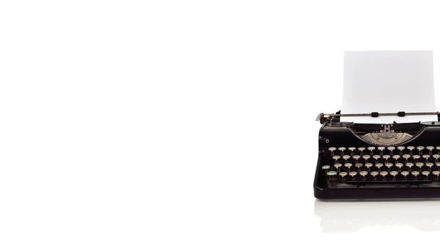 Vintage typewriter with blank paper on a white background