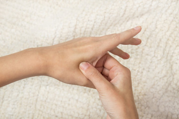 acupressure, the girl does self-massage; massaging points on the hands