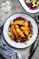 Salad with warm glazing chicken, sprinkled with sesame seeds. Chinese cuisine. Asian culture