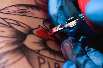 Process of making tattoo close-up - obrazy, fototapety, plakaty