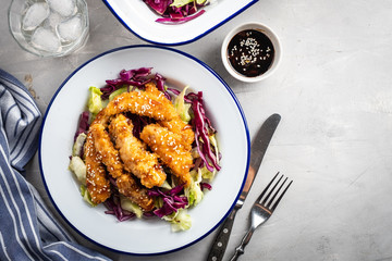 Salad with warm glazing chicken, sprinkled with sesame seeds. Chinese cuisine. Asian culture
