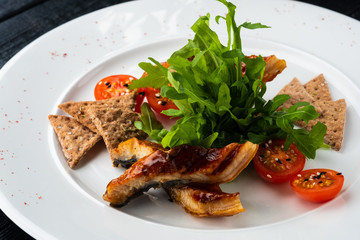 Sliced eel in flavored soy sauce glaze.