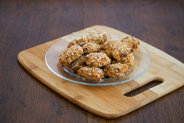 Homemade oatmeal cookies with coconut chips, muesli, dried apricots and other delicacies. Sweet and healthy snack,