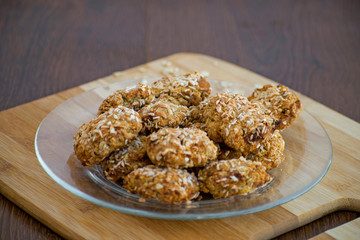 Homemade oatmeal cookies with coconut chips, muesli, dried apricots and other delicacies. Sweet and healthy snack,