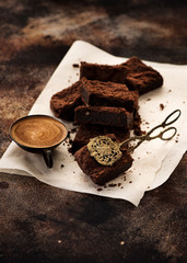 chocolate brownies, a cup coffee and cake tongs