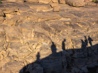 Shadow of travelers on rock background