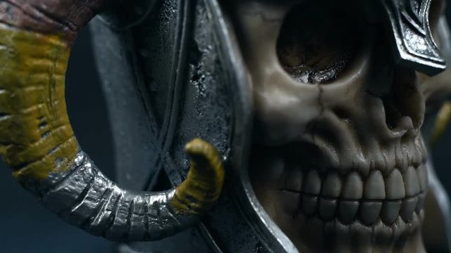 Skull of the human in metal helmet with horns.
