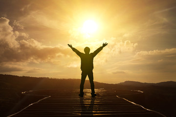 Men raise their arms to thank God.