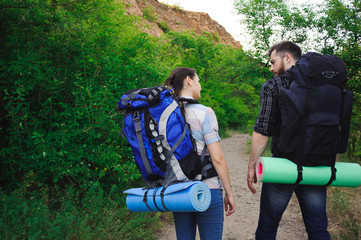 Two Young Tourists With Backpacks