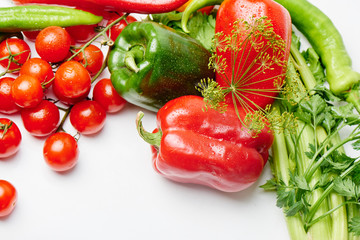 Peppers, cherry tomatoes, eggplants and dill on a white background with a copy space. Fresh multicolored vegetables..
