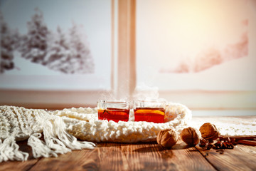 Mulled wine on a wooden table in a winter scenery  