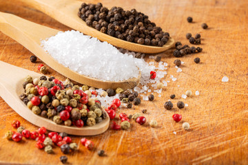 Fototapeta na wymiar Spices in Wooden spoons - focus on the sea salt