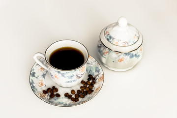 coffee, black or with milk, in a Cup next to the sugar bowl 