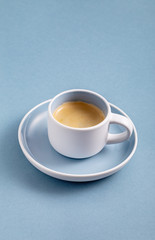 Single black coffee cup on blue background