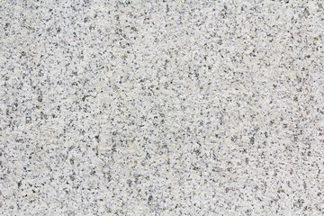 Texture gray granite. Smooth light stone texture. Uniform surface with stone grinding. Gray stone with dark inclusions. Material for decoration, background texture, interior design.